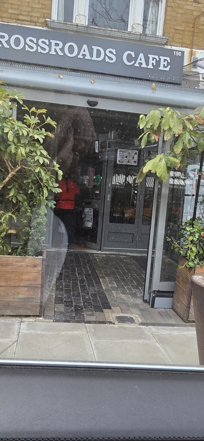 The cafe entrance and doorway, cropped in close below the fascia
