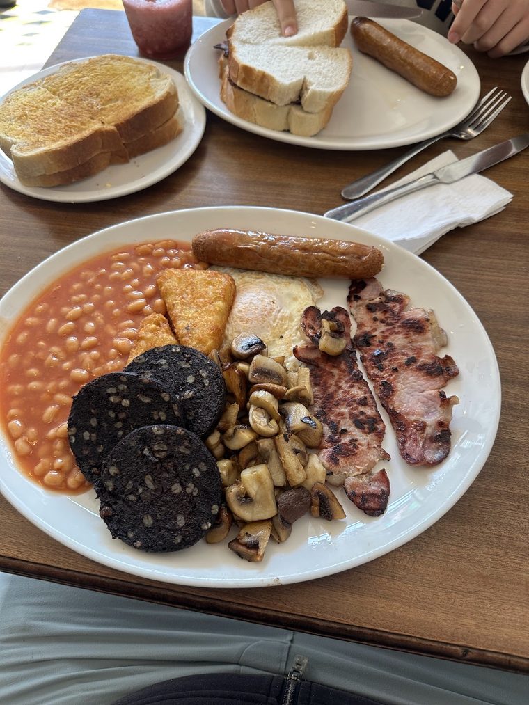 A large fry-up with beans, black pudding, mushrooms, bacon, sausage and egg