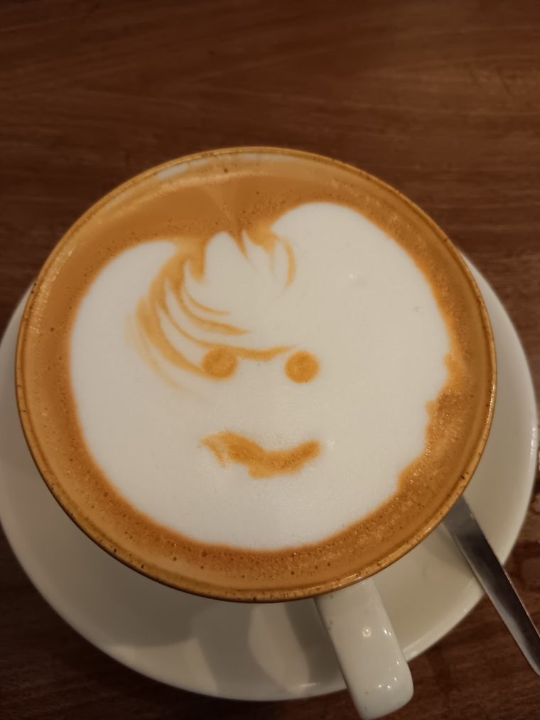 A latte with a smiley face in the foam